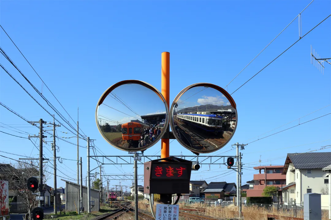 Trains at a station seen in a mirror