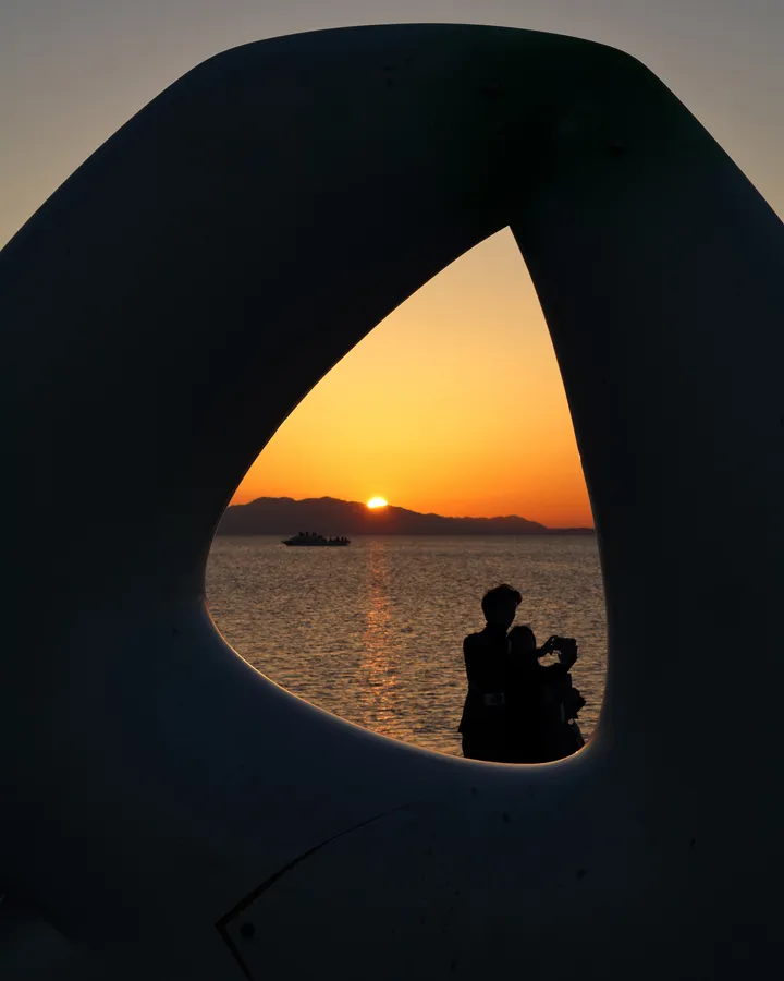 Sunset over Lake Shinji framed by sculpture