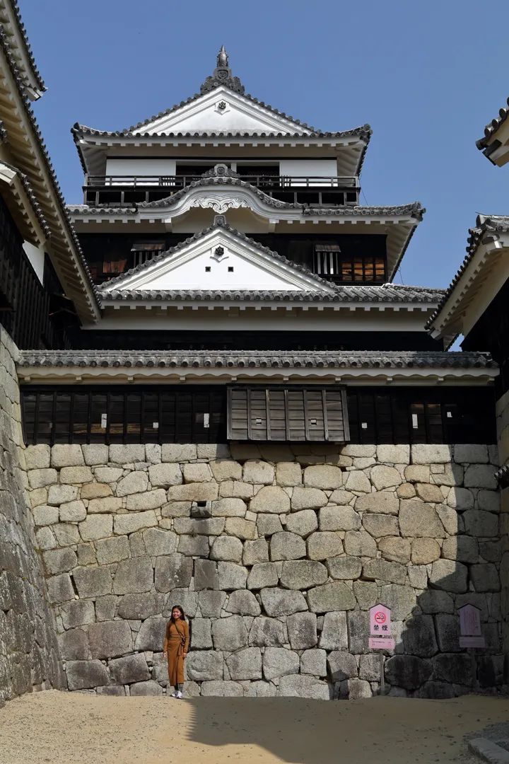 Main keep of Matsuyama Castle with a person for scale