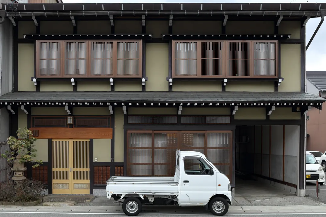 Small truck in front of a house